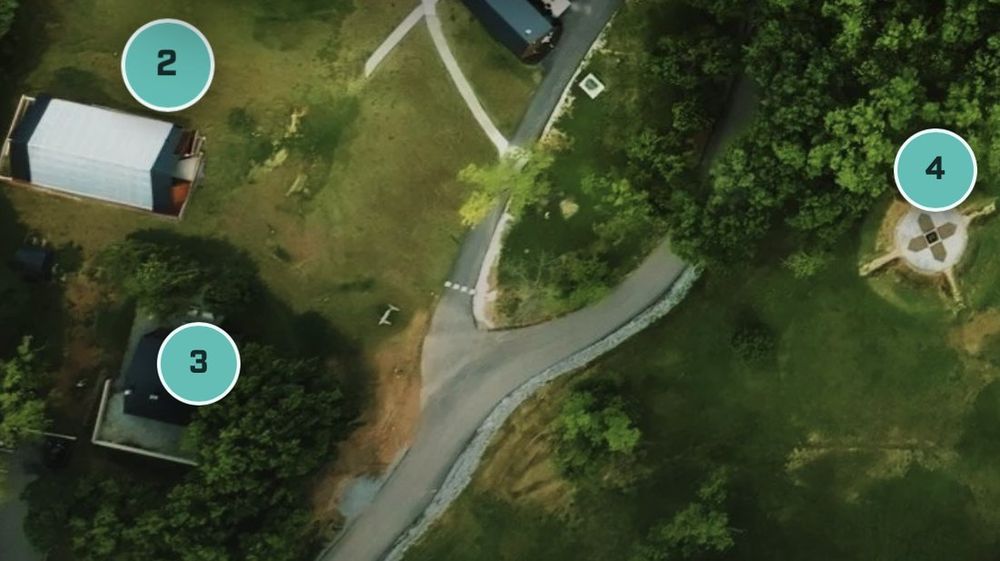 Aerial view of the UHP campus along the Spavinaw River, including the greenhouse